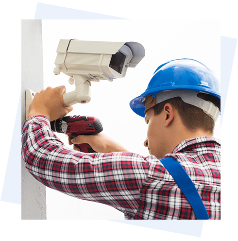 A man in blue hard hat and plaid shirt holding a drill.