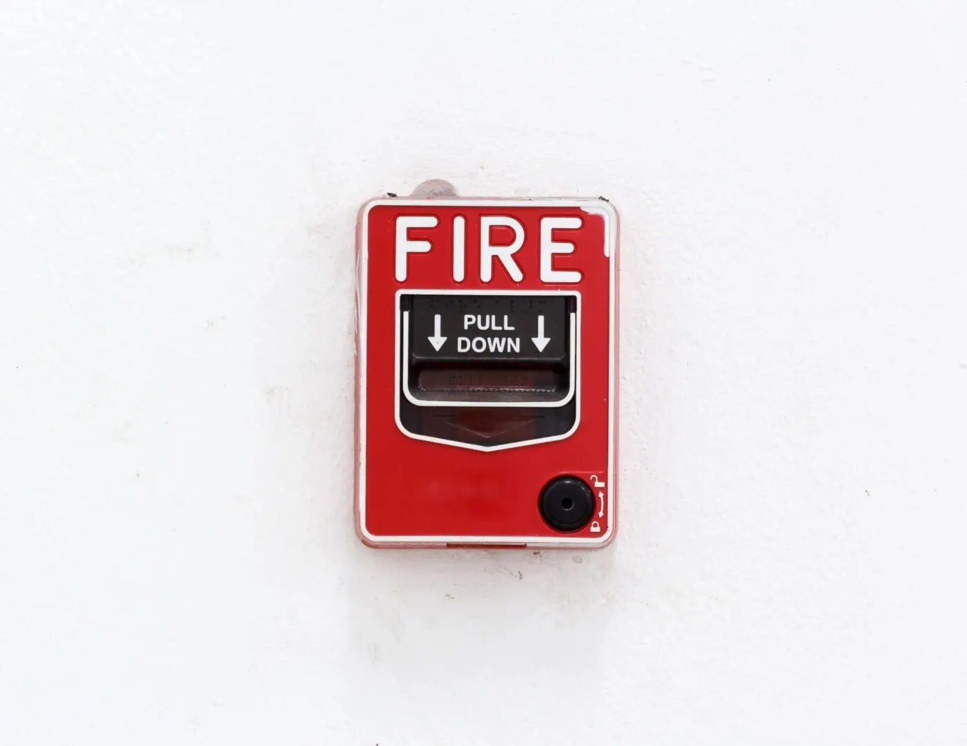 A fire alarm on the wall of a building.